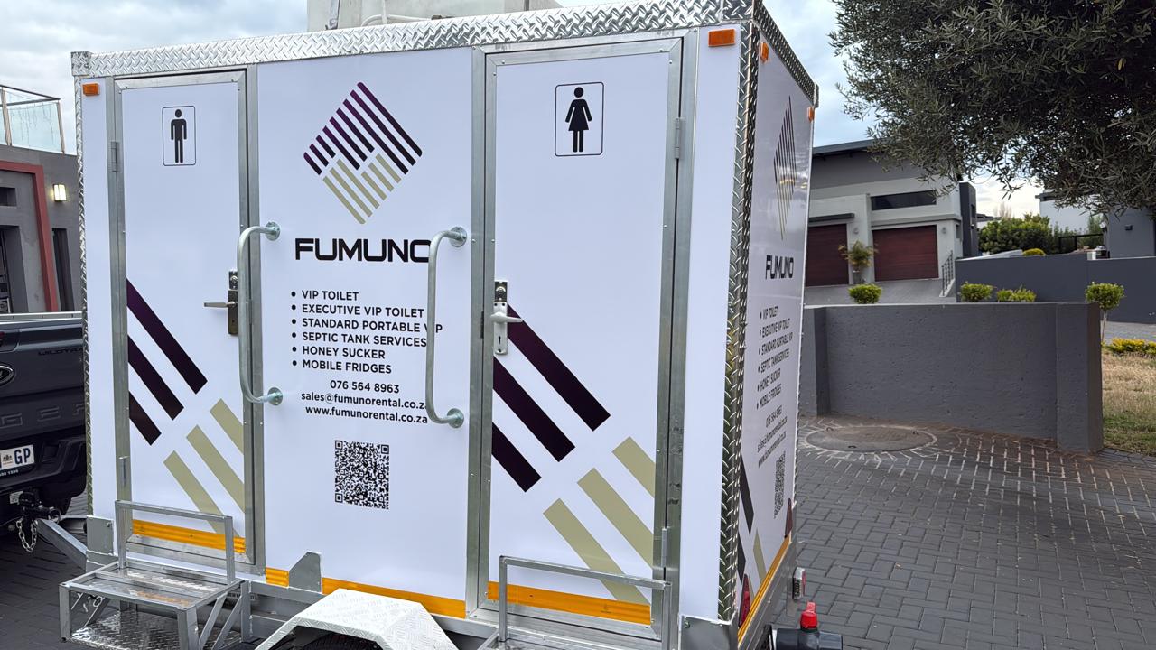 Fumuno VIP mobile toilet trailer in branded purple-and-gold livery, side view