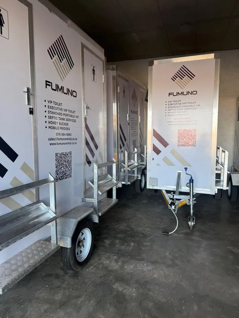 Row of Fumuno-branded VIP mobile toilet trailers parked in the Fumuno yard in Gauteng, serviced and ready for delivery