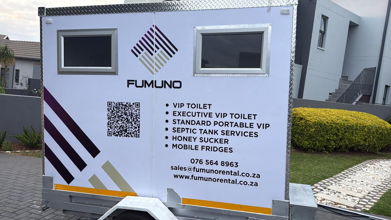 Front of a Fumuno VIP mobile toilet trailer showing branded service list — VIP toilets, mobile fridges, septic services — with QR code